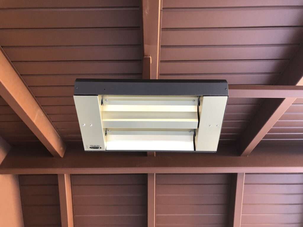 Ceiling-mounted fluorescent light fixture with wooden beams.