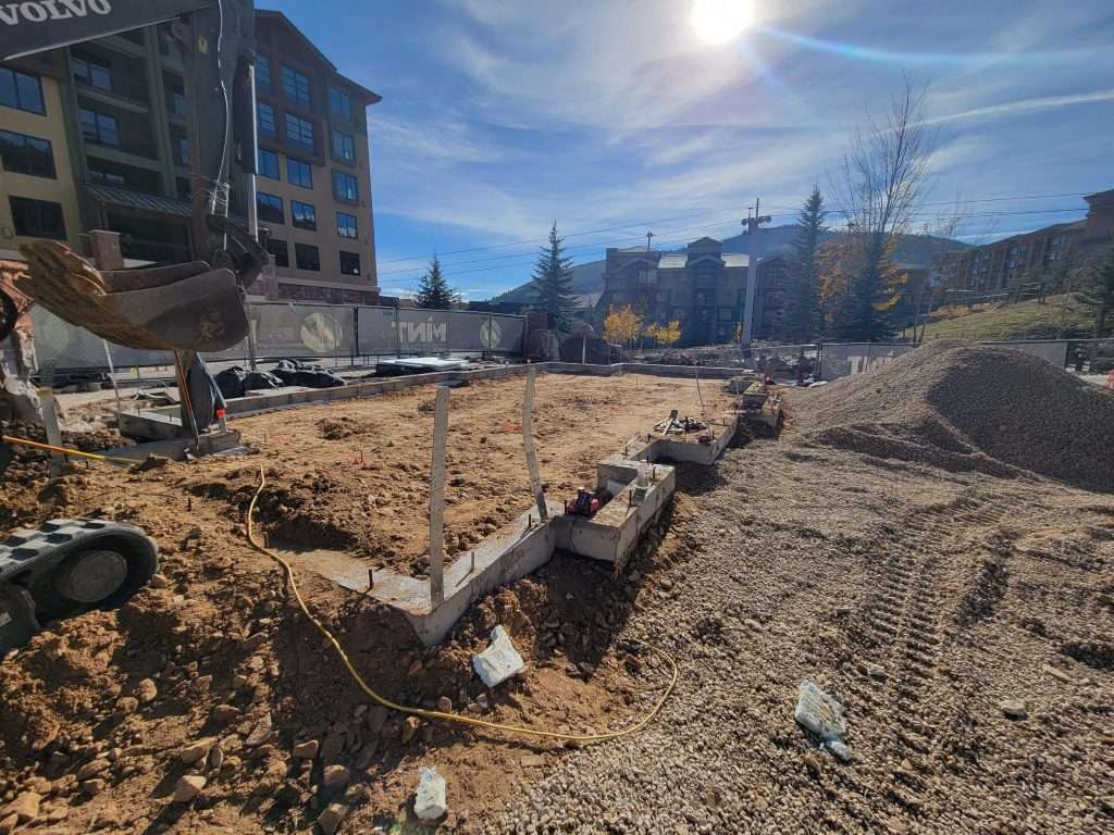 Construction site with foundation work on a sunny day.