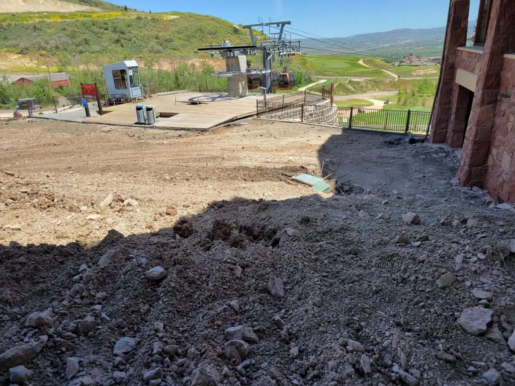 Construction site with dirt and machinery in a rural area.