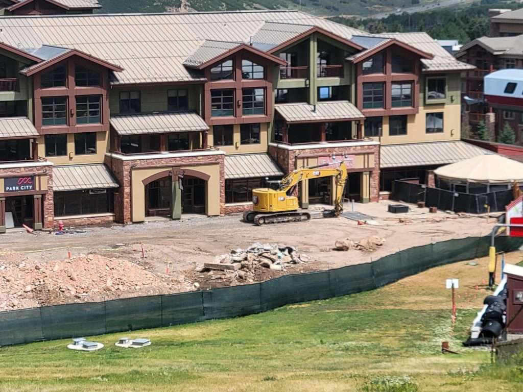 Construction site of a multi-story building with machinery and materials.