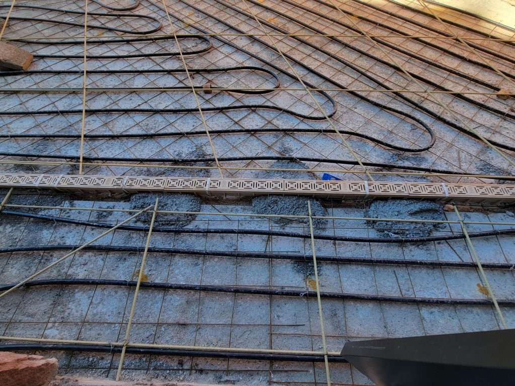 Roof under construction with heating pipes laid out.
