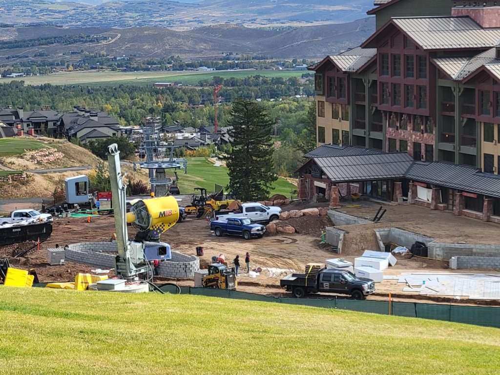 Construction work near a large hotel in a valley.