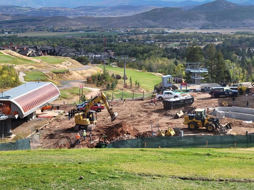 Construction site with heavy machinery working on land development.