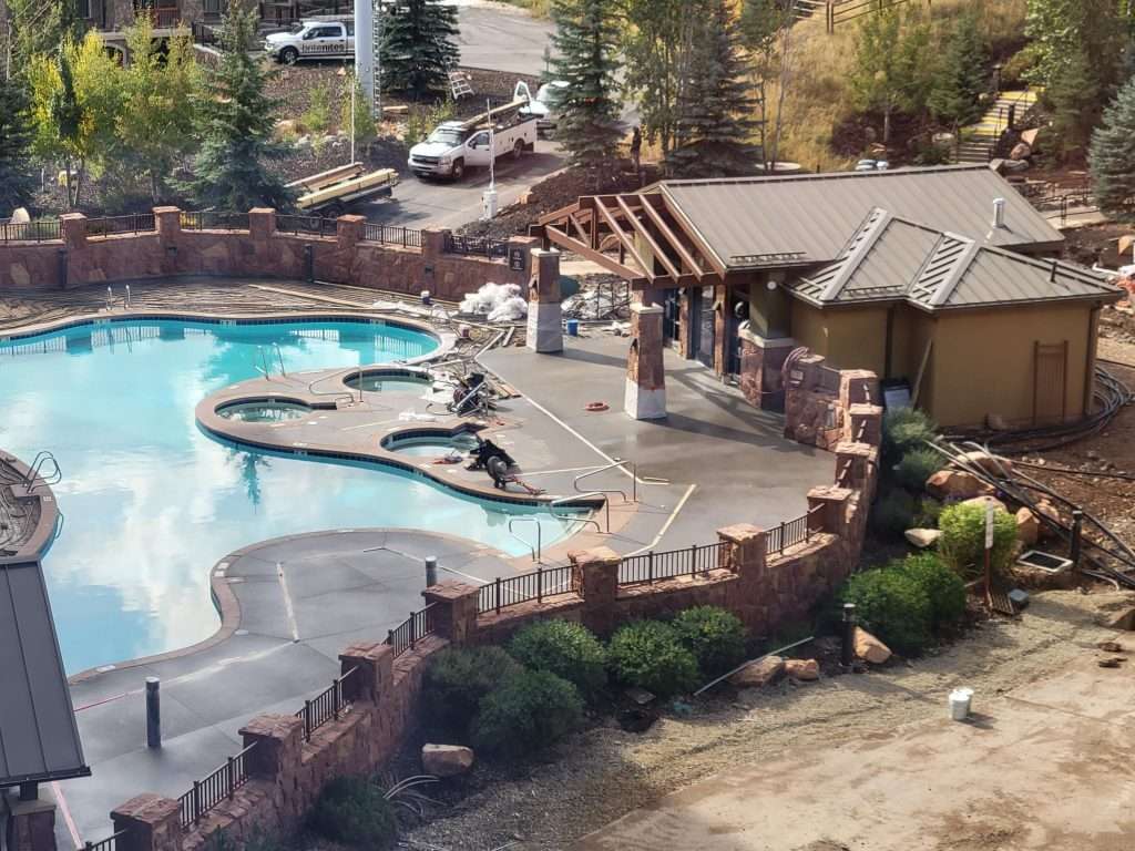 Outdoor pool area with lounge chairs and a shaded pavilion.