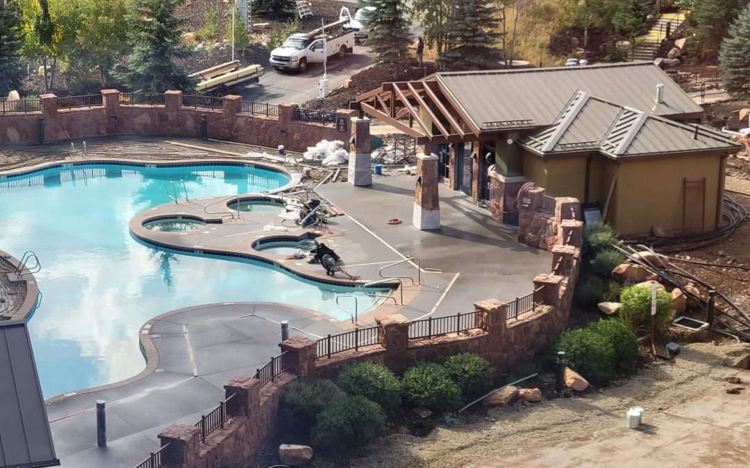 Outdoor pool area with lounge chairs and a shaded pavilion.