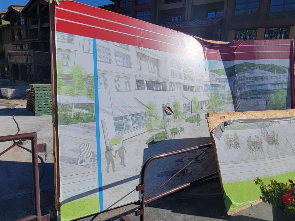 Architectural blueprint displayed on a board at an outdoor event.