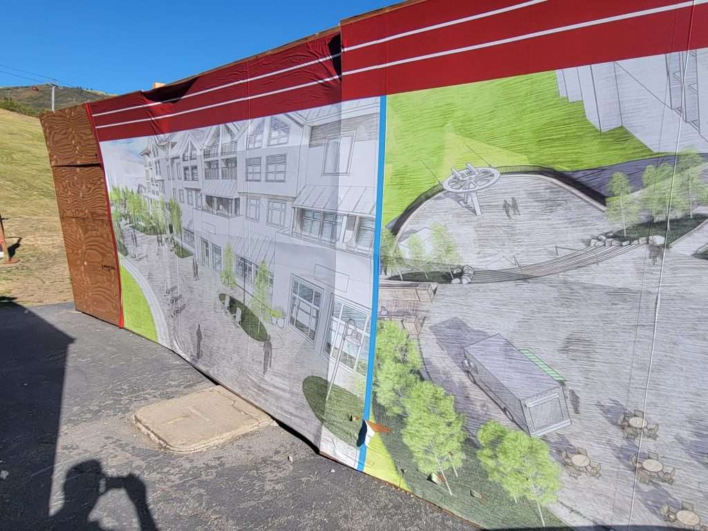 Outdoor display board showing a large fish and informational text under a red canopy.