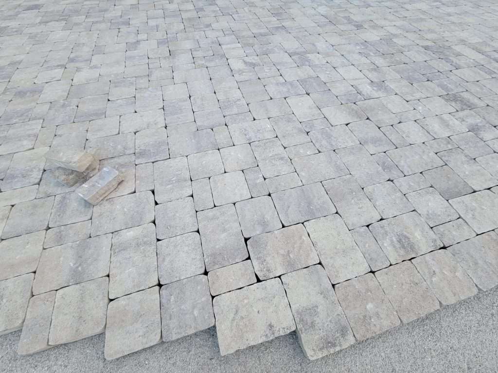Close-up of square stone tiles arranged in a grid pattern.