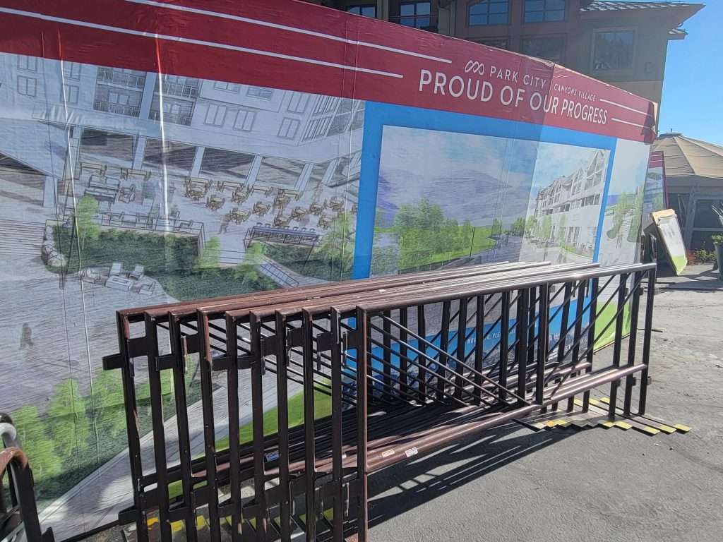 Empty bus stop shelter with a bench and informational panels.