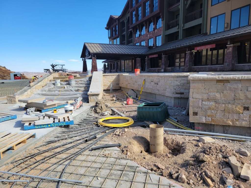Construction site with building foundation and materials in place.