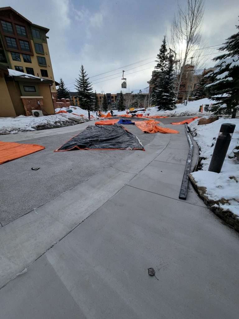 Construction site with concrete work in snowy environment.